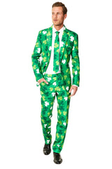 A person in a Suitmeister St Patricks Day Clovers green suit with white and light green shamrocks, complemented by a matching tie and white shirt. They are standing against a plain white background, wearing black shoes.