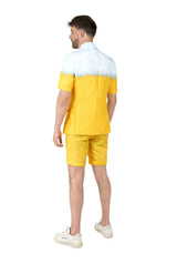 A man stands with his back turned, wearing the Suitmeister Premium Beer Yellow novelty suit—featuring a white foam top, yellow bubbles, matching shorts, and white sneakers—against a plain white background.