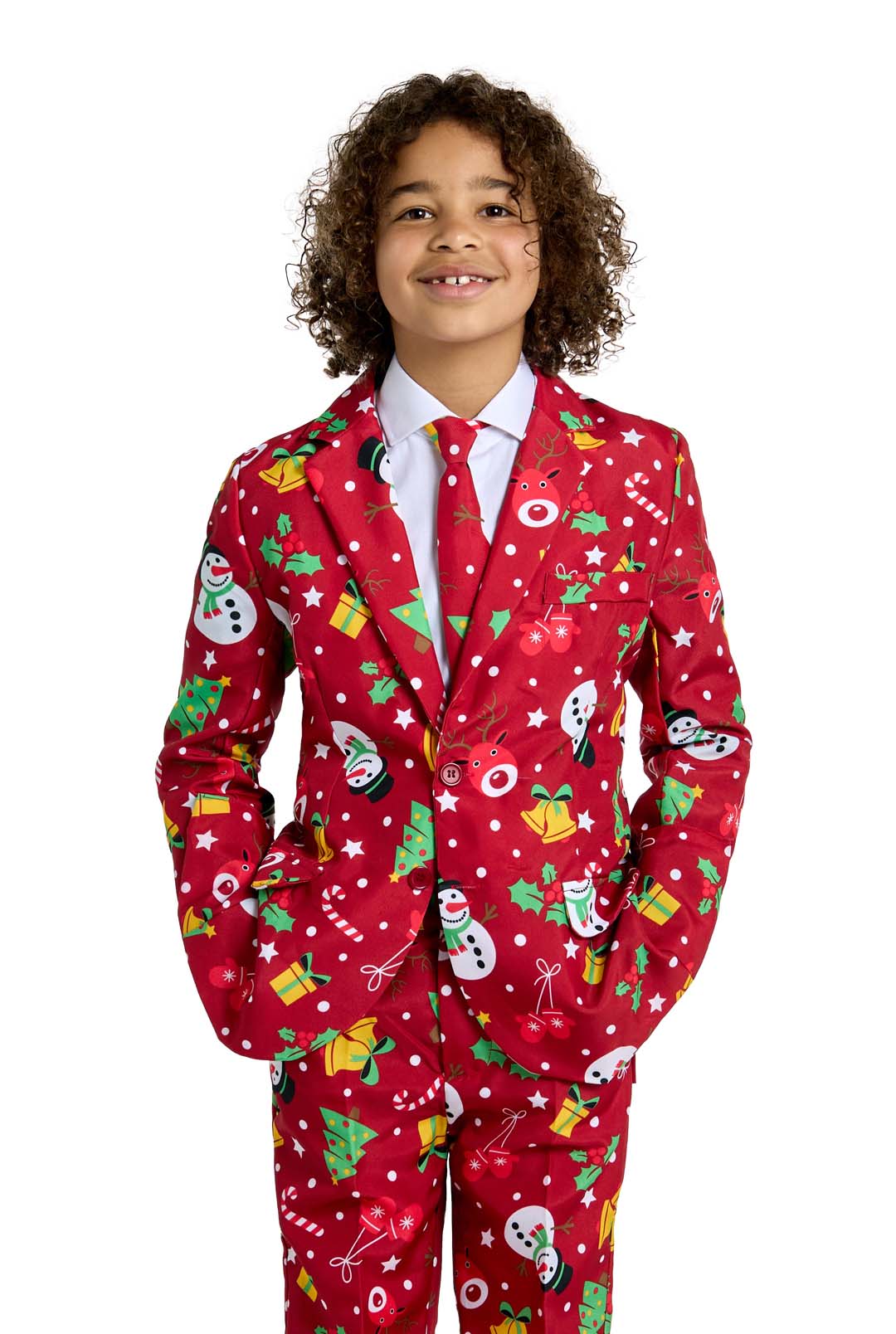 A smiling child with curly hair wears the Suitmeister BOYS Christmas Red Icons - Light Up suit, featuring festive patterns like snowmen, presents, trees, and ornaments, standing against a white background.