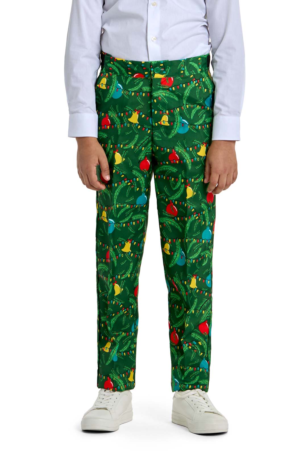 A child models the Suitmeister BOYS Christmas Green Tree - Light Up outfit, featuring a white dress shirt and green pants with festive tree and ornament patterns, paired with white sneakers. Photo is cropped from shoulders to feet.