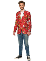 A man smiles in a Suitmeister Christmas Red Icons - Light Up blazer, paired with a white shirt, blue jeans, and black-and-white sneakers against a plain white background.