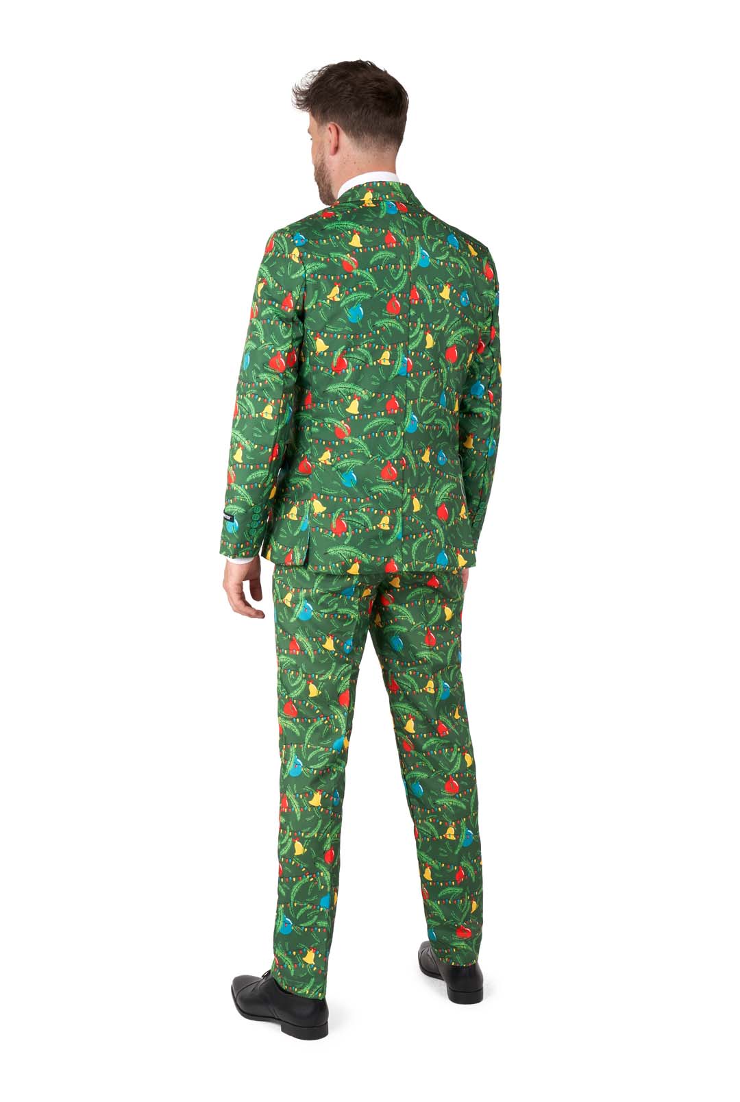 A man with short hair wears the Suitmeister "Christmas Green Tree - Light Up" suit featuring a festive pattern of ornaments, lights, and decorations in green. He faces away, wearing black shoes against a white background.