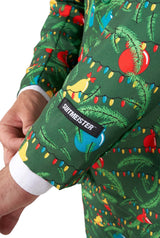 A close-up of the Suitmeister Christmas Green Tree - Light Up suit sleeve, decorated with colorful Christmas lights and ornaments. The SUITMEISTER label, part of a person’s hand, and a white shirt cuff are also visible.