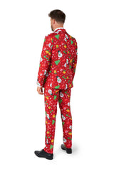 A man faces away, dressed in the Suitmeister Christmas Red Icons - Light Up suit featuring snowmen, Christmas trees, presents, and white snowflakes. He wears black shoes and stands against a plain white background.