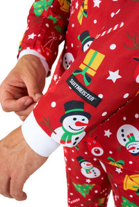 A person adjusts the cuff of a Suitmeister Christmas Red Icons - Light Up suit sleeve, featuring festive snowmen, Christmas trees, gifts, candy canes, and stars. A black Suitmeister label is attached to the sleeve.