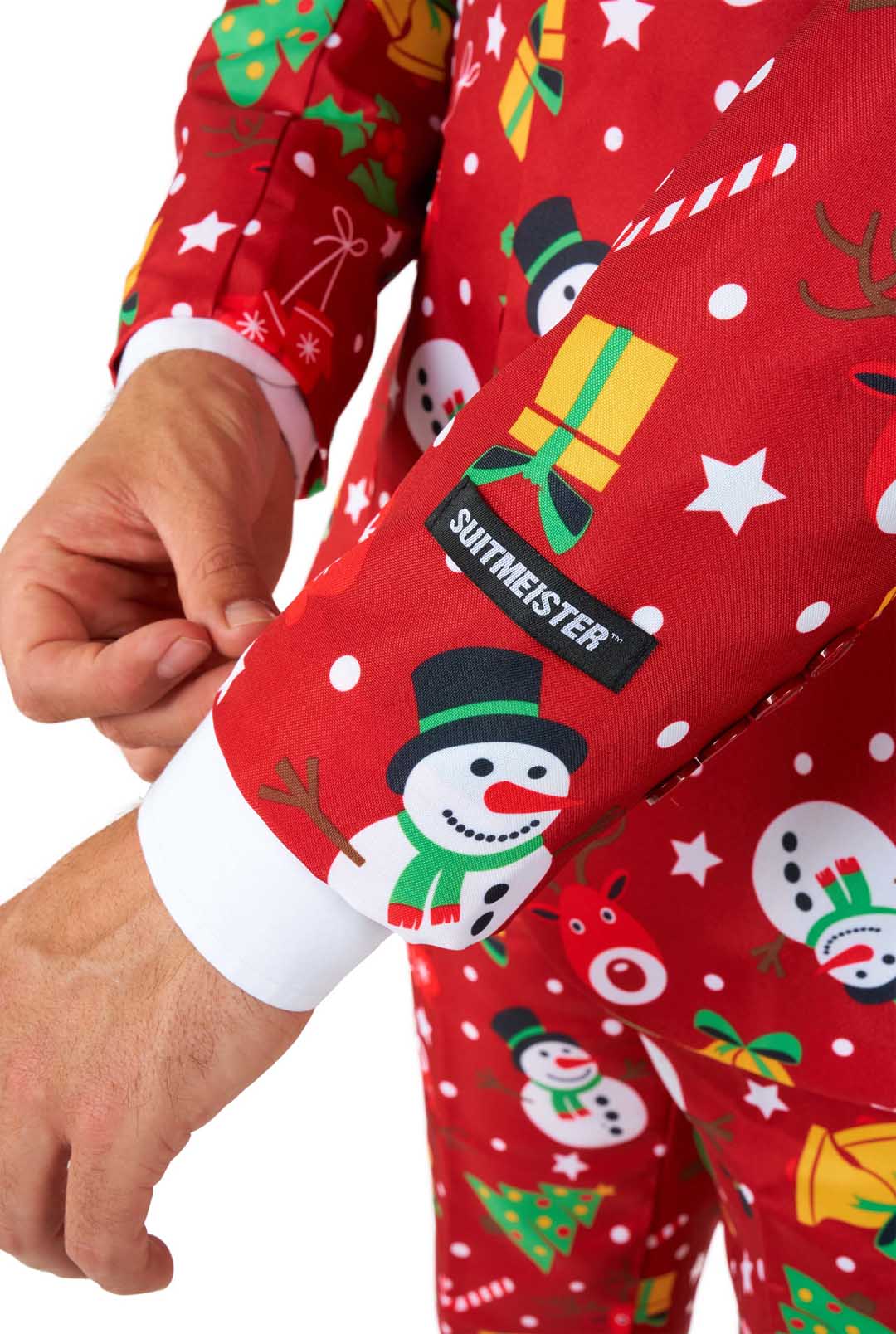 A person adjusts the cuff of a Suitmeister Christmas Red Icons - Light Up suit sleeve, featuring festive snowmen, Christmas trees, gifts, candy canes, and stars. A black Suitmeister label is attached to the sleeve.