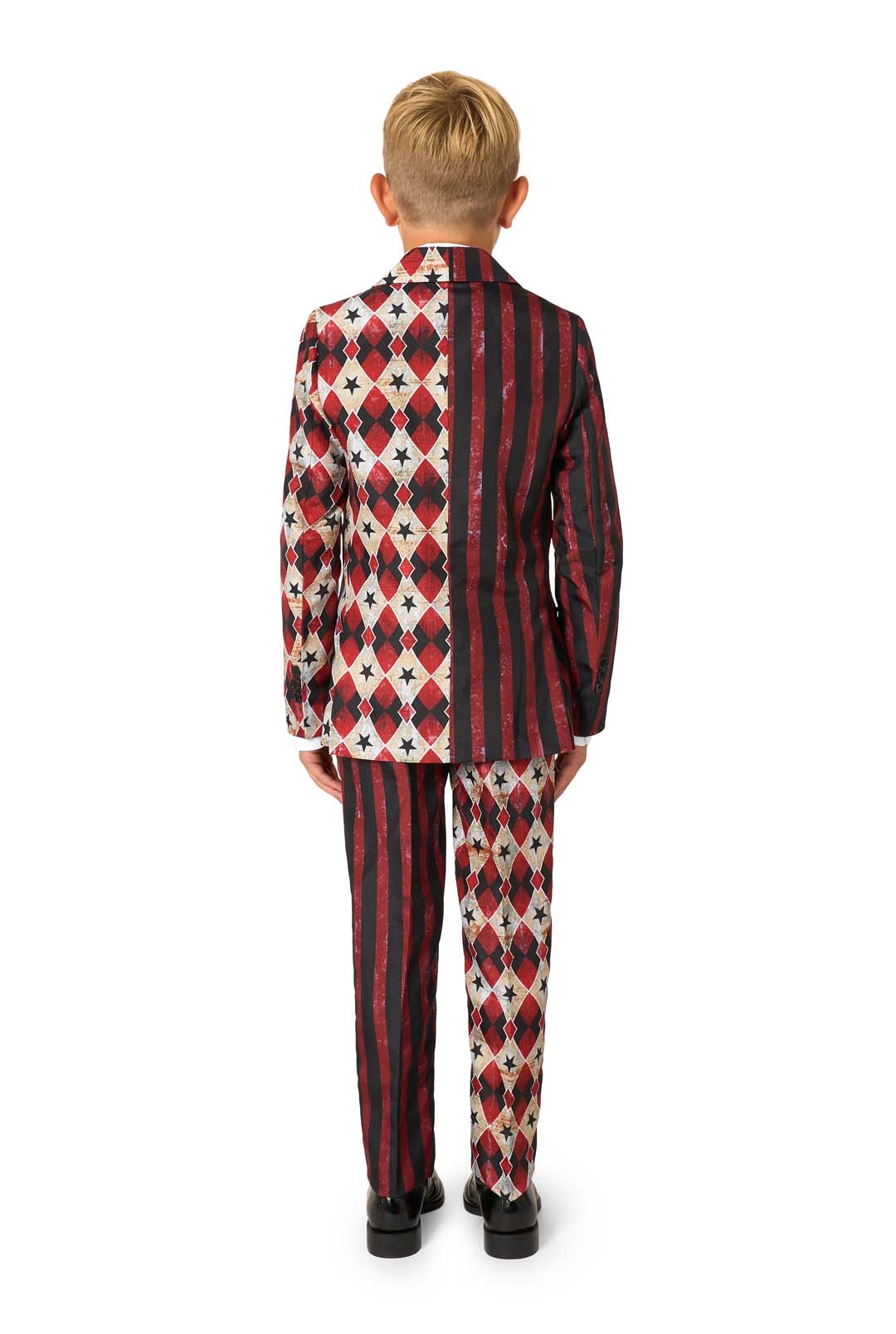A young boy with short blond hair faces away, wearing the Suitmeister Scary Clown Red suit with bold red, black, and white diamonds, stars, and stripes, and black shoes, set against a plain white background.