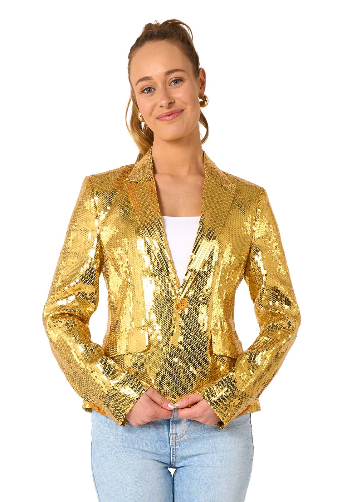 A person models the Suitmeister Sequins Gold sequin blazer over a white top and light blue jeans, standing and smiling with hands clasped against a plain white background.