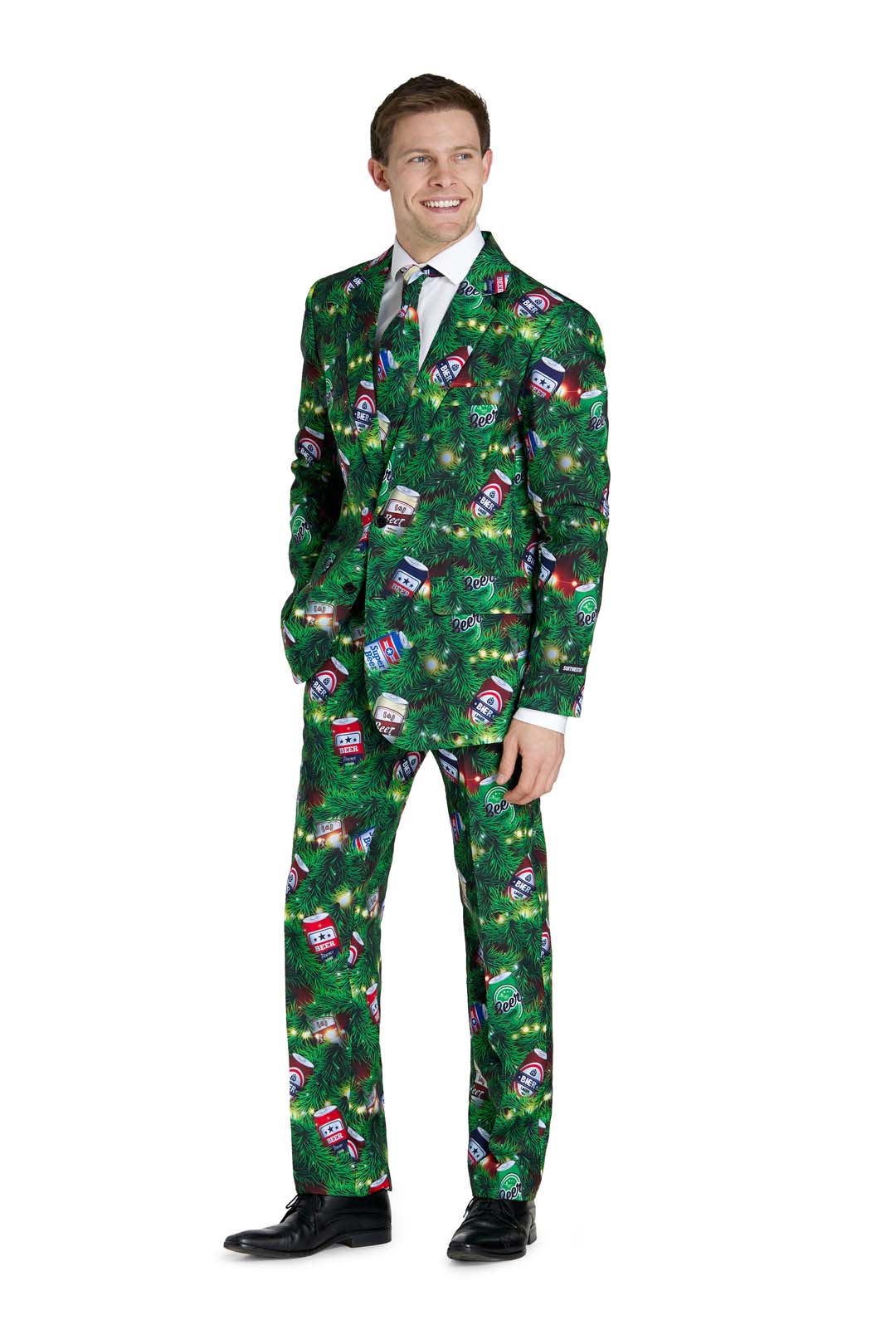 A man stands smiling with his hands in his pockets, dressed in Suitmeister’s Christmas Beers Green suit—a festive green outfit with a holiday print—paired with a white shirt, black tie, and black shoes.