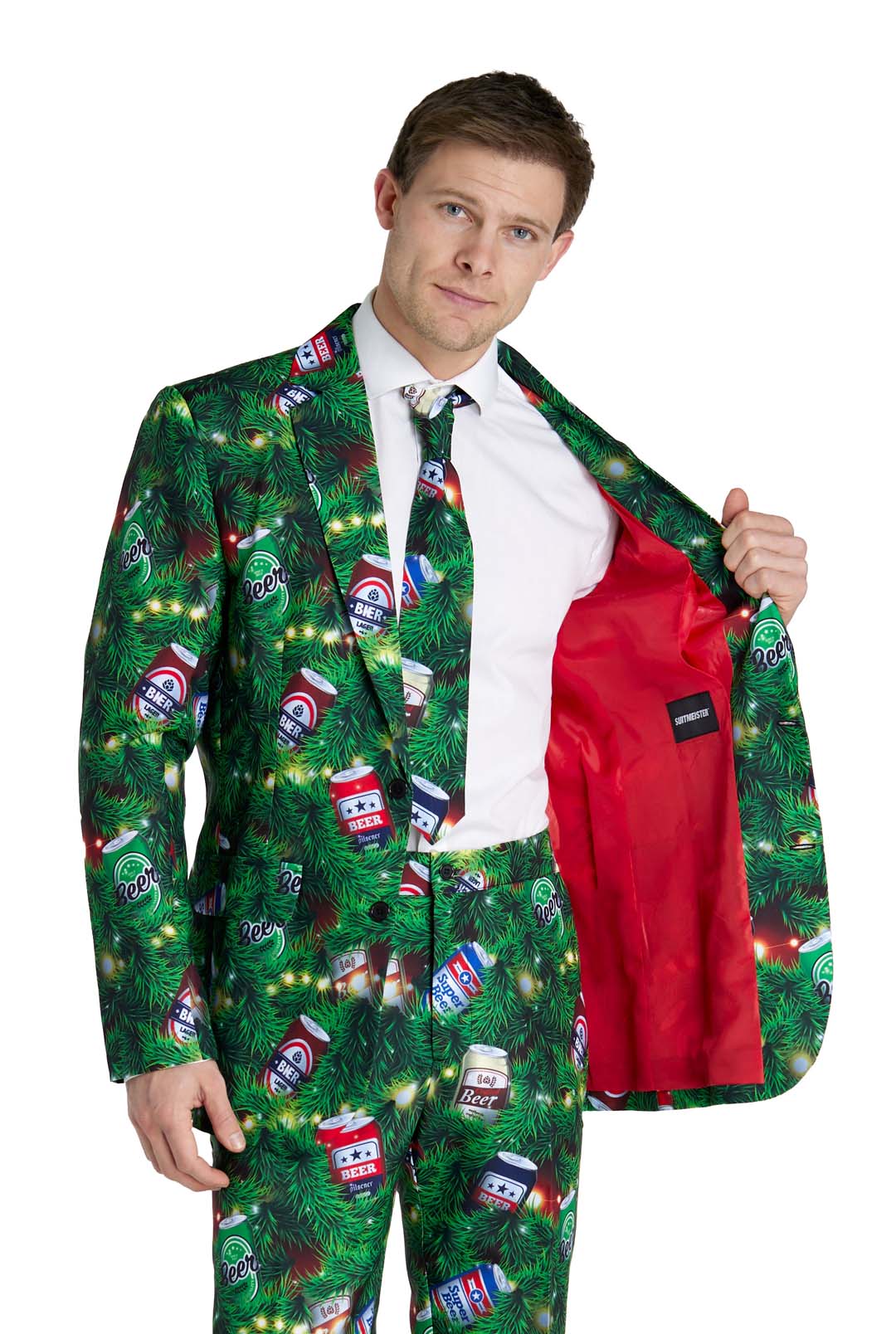 A man models the Suitmeister Christmas Beers Green suit, featuring a green pine branch and beer can pattern, with a bright red lining visible as he opens his jacket. He stands against a plain white background.