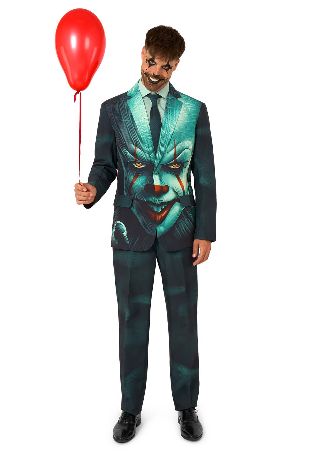 A man wears the Suitmeister IT™ Halloween suit, featuring a scary clown face print, creepy clown makeup, and holds a red balloon against a white background.