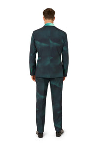A man faces away from the camera, wearing the Suitmeister IT™ Halloween suit—dark teal with matching pants—and black dress shoes against a white background.