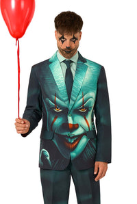 A man wears the Suitmeister IT™ Halloween suit, featuring Pennywises face, and holds a red balloon. His face is painted with dark clown makeup as he poses against a plain white background.