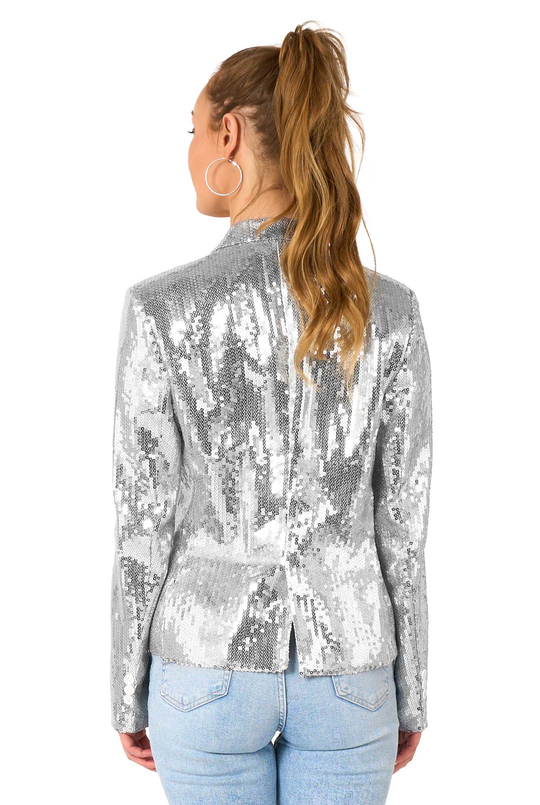 A woman with long, wavy hair in a high ponytail faces away, wearing the Suitmeister Sequins Silver sequin blazer and light blue jeans against a white background.